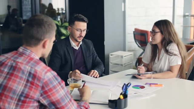 Coworkers in a modern office working on project in company