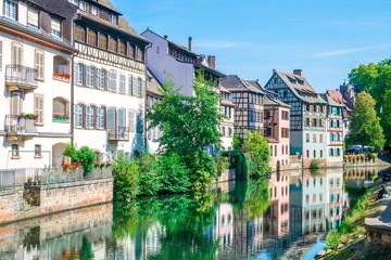 Typical house near water and flowers from La Petite France in Strasbourg, Alsace, France