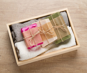 Handmade soap and towels in wooden box