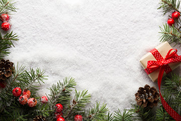 Obraz na płótnie Canvas Christmas background with decorations and gift box on snow