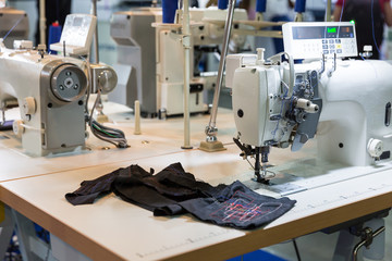 Sewing machine and cloth in cutting shop, nobody