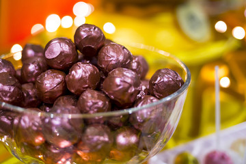 Purple chocolate bonbons in a bowl