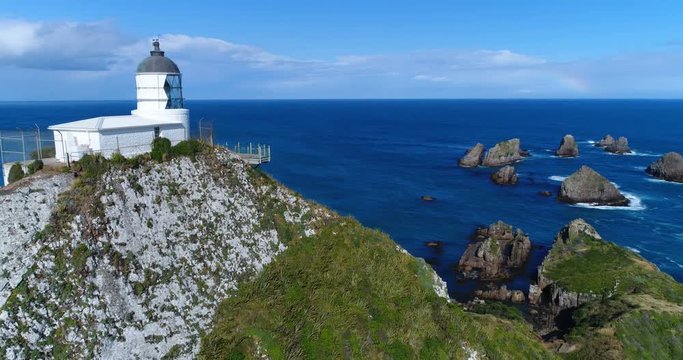 New Zealand aerial drone footage of Nugget Point Lighthouse in Otago region and peninsula on South Island of New Zealand. Beautiful tourist destination and attraction seen from above.