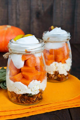 Food in a jar: granola with nuts, cottage cheese, slices of boiled pumpkin, mascarpone cream. A useful breakfast. Lunch at work. Proper nutrition.