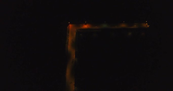 Aerial shot at night of coastal city Palanga lights with view of sea bridge