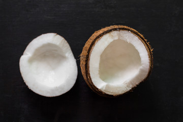top view fresh half coconut  on black background