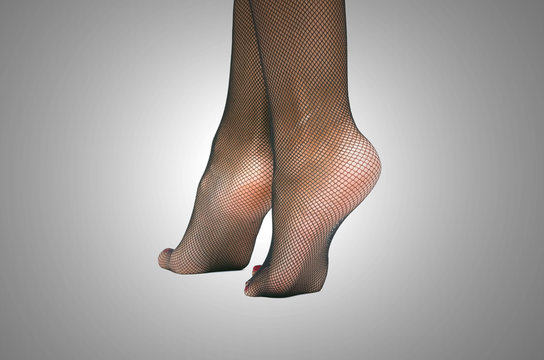 Legs up; Closeup slim legs of a woman in red pantyhose or sheer