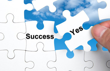 Fototapeta premium White jigsaw puzzle with Success and Yes word, business concept.