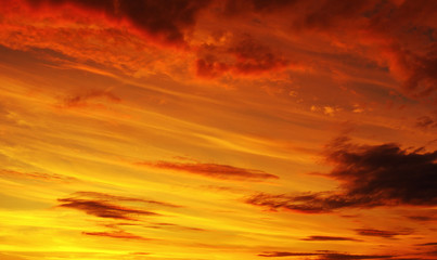 Obraz premium Photo of orange sunset with dark clouds on sky