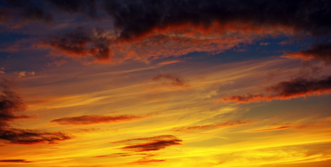 Fototapeta premium Photo of orange sunset with dark clouds on sky