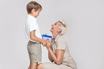 Mom posing with young son, smiling.