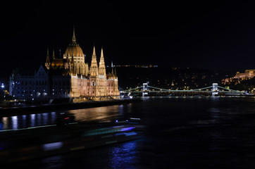 Hungarian Parliament and the Danube river illuminated at night.