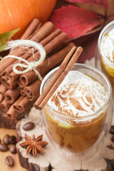 Pumpkin latte or cocktail (smoothie) with spices - cinnamon, anise, coffee. Hot or cold fall drink. Selective focus