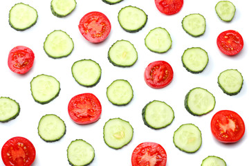 mix of sliced cucumber with sliced tomato isolated on a white background top view