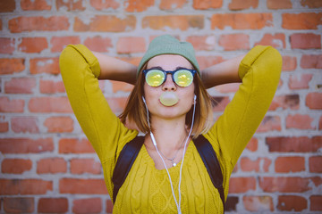 Portrait of a beautiful young hipster girl with  sunglasses