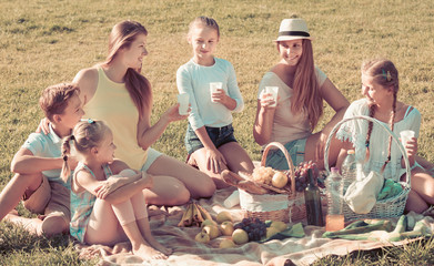 Portrait of adult women with children on picnic
