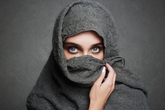 beautiful arab woman covers her face