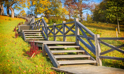 Autumnal old park with wooden stairs. Holiday and vacation travel concept
