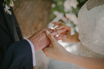 The bride wears a ring to the groom