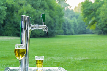 Beer tap machine in front of a clearing