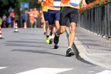 Fototapeta na wymiar athletes run in the street in the city