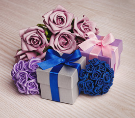 Gift Box with a bouquet of flowers on a wooden background