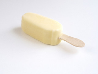 Ice cream covered with white chocolate on white background