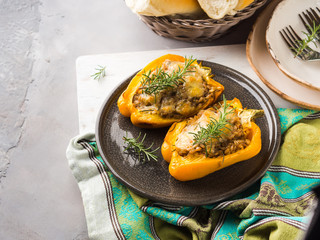 Bell peppers stuffed with barley and meat baked on gray. Complex lunch with vegetables, cereal and meat