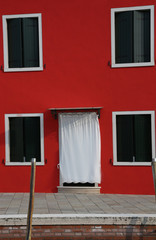 red house on the island of Burano near VENICE in Italy
