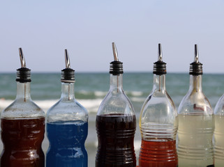 sugary syrup bottles to prepare drinks and grenades on the beach