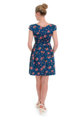 a beautiful young girl in a dress posing on a white background