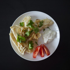 dumplings with tomatoes and sour cream