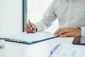 Fototapeta premium Signing a car insurance policy, the agent is holding the document