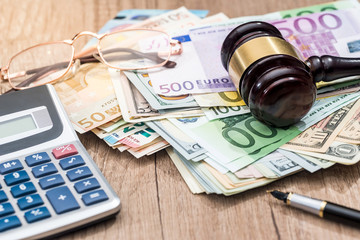 dollar,  euro, gavel, glasses, calculator and pen