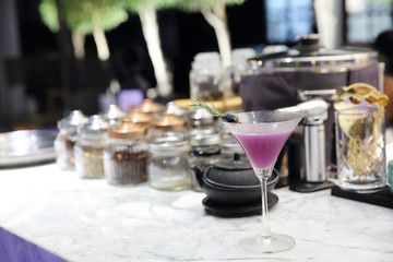 Purple cocktail on bar background