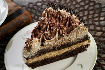 Cup of tea and Delicious chocolate cake with whipped cream
