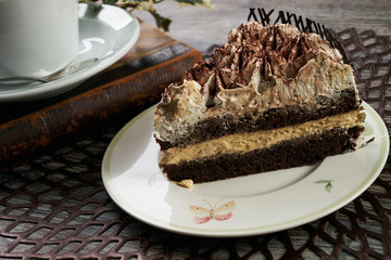 Cup of tea and Delicious chocolate cake with whipped cream