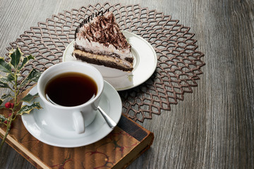 Cup of tea and Delicious chocolate cake with whipped cream