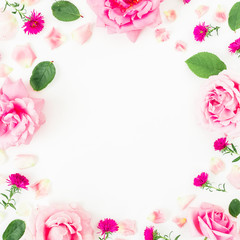 Floral frame with pink flowers, petals and leaves on white background. Flat lay, top view. Flower background