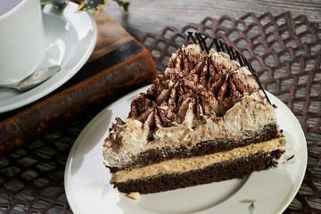 Cup of tea and Delicious chocolate cake with whipped cream