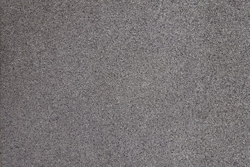 Surface of grey exterior wall with pebbledash