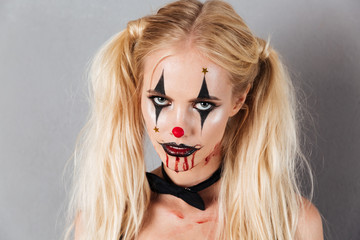 Close-up portrait of carefree blonde woman in halloween make up