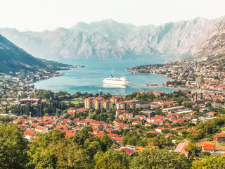 Fototapeta na wymiar View of Kotor, Montenegro. Kotor Bay is one of the most beautiful places on the Adriatic Sea, a preserved Venetian fortress, old tiny villages, medieval towns and picturesque mountains.