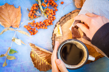 Autumn coffee with chocolate on a blue background