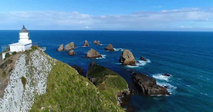 New Zealand aerial drone footage of Nugget Point Lighthouse in Otago region and peninsula on South Island of New Zealand. Beautiful tourist destination and attraction seen from above.