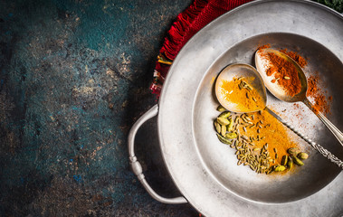 Colorful spices in spoons on vintage metal plate for Asian, oriental  or indian cuisine concept