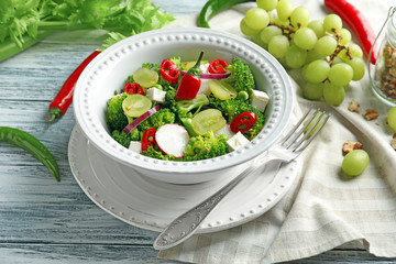 Dish with broccoli salad on table