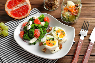 Plate with broccoli salad on table