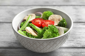 Bowl with broccoli salad on table