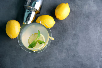 Glass of lemon drop martini with zest on table